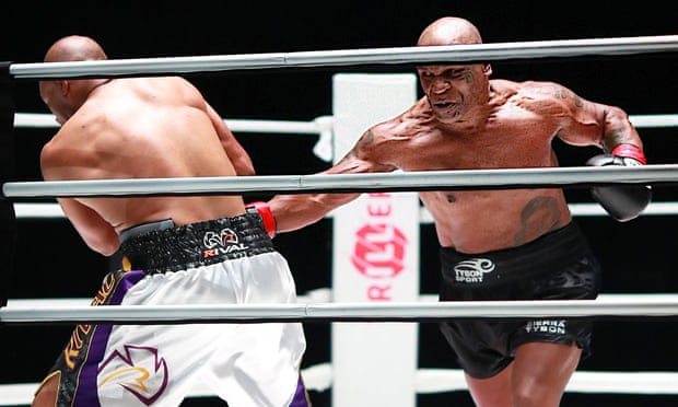 Mike Tyson (right) hits Jones. Photo: USA Today Sports.